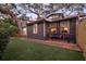 Charming home featuring a brick pathway, inviting swing, and well-manicured lawn at 1005 Main St, Safety Harbor, FL 34695