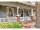 Charming front porch with brick accents, white railing and updated features, creating a welcoming entrance at 1005 Main St, Safety Harbor, FL 34695