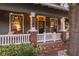 Charming front porch with classic architectural details, brick accents, and a cozy seating area at 1005 Main St, Safety Harbor, FL 34695