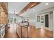 Open kitchen and living room features a rustic design, with a wooden table and beam at 1005 Main St, Safety Harbor, FL 34695