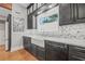Modern kitchen featuring dark cabinets, white countertops, a farmhouse sink, and stainless steel appliances at 1005 Main St, Safety Harbor, FL 34695