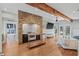 Bright living room featuring hardwood floors, brick accent wall, and stylish furniture at 1005 Main St, Safety Harbor, FL 34695