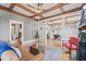 Cozy living room with a fireplace, coffered ceiling, hardwood floors, and open access to the dining area at 1005 Main St, Safety Harbor, FL 34695