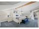 Bright main bedroom features a beamed ceiling, closet space, and carpeting at 1005 Main St, Safety Harbor, FL 34695