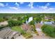 Aerial shot featuring a home in a tranquil neighborhood near a pond with lush trees, serene living at 10112 Downey Ln, Tampa, FL 33626