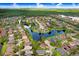 Scenic aerial of a home nestled in a neighborhood surrounding a pond, highlighting the community's layout at 10112 Downey Ln, Tampa, FL 33626