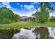 Scenic backyard with a tranquil pond view enhancing the property's peaceful setting at 10112 Downey Ln, Tampa, FL 33626