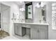 Stylish bathroom featuring double vanity with modern sinks, gray cabinets, and sleek fixtures at 10112 Downey Ln, Tampa, FL 33626
