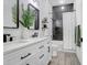 Modern bathroom with double vanity, black fixtures, subway tile shower, and contrasting black and white design at 10112 Downey Ln, Tampa, FL 33626