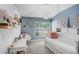 Cozy bedroom with light blue walls, white trim, and a comfortable daybed with pink accents at 10112 Downey Ln, Tampa, FL 33626