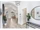 Bright foyer features wood-look floors, arched doorways and modern lighting fixture at 10112 Downey Ln, Tampa, FL 33626
