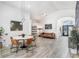 Open-concept living room features modern lighting, and wood-look floors at 10112 Downey Ln, Tampa, FL 33626