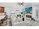 Stylish living area with modern fireplace, wood-look floors, and seamless flow into the kitchen at 10112 Downey Ln, Tampa, FL 33626