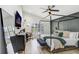 Stylish primary bedroom features natural lighting, a ceiling fan, and a decorative bed frame at 10112 Downey Ln, Tampa, FL 33626