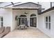 Inviting covered patio featuring a dining table and chairs, perfect for outdoor entertainment and relaxation at 10112 Downey Ln, Tampa, FL 33626