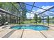 Resort-style pool with a waterfall feature and lush landscaping, perfect for relaxation with picturesque lake views at 10112 Downey Ln, Tampa, FL 33626