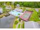 Overhead view of the community featuring a pool, tennis courts, and lush landscaping at 1109 Pine Ridge W Cir # C1, Tarpon Springs, FL 34688