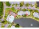 Aerial view of community amenities: pool, tennis courts, buildings, parking at 1109 Pine Ridge W Cir # C1, Tarpon Springs, FL 34688