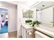 Well-lit bathroom with a vanity and a view into the bedroom at 1109 Pine Ridge W Cir # C1, Tarpon Springs, FL 34688