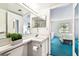 Bright bathroom featuring a single vanity and a view of the bedroom at 1109 Pine Ridge W Cir # C1, Tarpon Springs, FL 34688