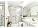 Bright bathroom featuring a glass-enclosed shower and a mirrored vanity with good lighting at 1109 Pine Ridge W Cir # C1, Tarpon Springs, FL 34688