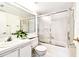Bright bathroom features a bathtub with sliding glass doors and a modern vanity at 1109 Pine Ridge W Cir # C1, Tarpon Springs, FL 34688