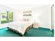 Bright bedroom featuring a queen-sized bed, a window with natural light, and a serene decor at 1109 Pine Ridge W Cir # C1, Tarpon Springs, FL 34688