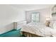 Bright bedroom featuring a queen-sized bed and a window providing natural light at 1109 Pine Ridge W Cir # C1, Tarpon Springs, FL 34688