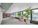 Inviting sunroom with bookshelves, seating, and views of the pool area, ideal for relaxation at 1109 Pine Ridge W Cir # C1, Tarpon Springs, FL 34688
