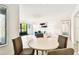 Bright dining area with view to an enclosed lanai, seamlessly connecting to the living room at 1109 Pine Ridge W Cir # C1, Tarpon Springs, FL 34688