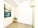 A bright, empty room with a modern art piece at 1109 Pine Ridge W Cir # C1, Tarpon Springs, FL 34688