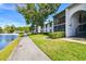 Inviting condo complex features screened lanais and a tranquil pond view with community pool at 1109 Pine Ridge W Cir # C1, Tarpon Springs, FL 34688