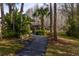Secluded community gazebo with a paved walking path, surrounded by trees and lush foliage at 1109 Pine Ridge W Cir # C1, Tarpon Springs, FL 34688