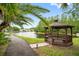 Scenic gazebo overlooking a tranquil pond, providing a peaceful retreat at 1109 Pine Ridge W Cir # C1, Tarpon Springs, FL 34688