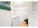 Laundry area with washer, dryer, shelving, and closet, freshly painted at 1109 Pine Ridge W Cir # C1, Tarpon Springs, FL 34688