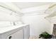 Bright laundry area with washer and dryer and shelving at 1109 Pine Ridge W Cir # C1, Tarpon Springs, FL 34688
