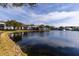 Community pond with fountain and lush landscaping and community buildings at 1109 Pine Ridge W Cir # C1, Tarpon Springs, FL 34688