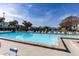 Sparkling community pool with lots of seating at 1109 Pine Ridge W Cir # C1, Tarpon Springs, FL 34688