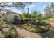 Landscaped backyard with brick paver path leading to screened-in patio at 11125 117Th St, Seminole, FL 33778