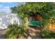 Backyard featuring a swing sheltered by mature trees and verdant plants at 11125 117Th St, Seminole, FL 33778