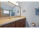 Bathroom features a wooden vanity, large mirror, and tiled shower at 11125 117Th St, Seminole, FL 33778