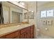 Bright bathroom with a vanity, sink, and decorative dragonfly window at 11125 117Th St, Seminole, FL 33778