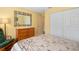 Bedroom featuring a dresser, a large mirror, and double-door closet at 11125 117Th St, Seminole, FL 33778