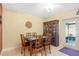 Cozy dining room features a decorative tile table, cabinet, and doorway to the lanai at 11125 117Th St, Seminole, FL 33778