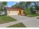 Home featuring a two-car garage and tidy landscaping at 11125 117Th St, Seminole, FL 33778