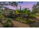 Landscaped backyard features brick walkway, decorative plants and enclosed patio at 11125 117Th St, Seminole, FL 33778
