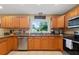 Well-equipped kitchen features ample counter space, wood cabinets, and stainless steel appliances at 11125 117Th St, Seminole, FL 33778
