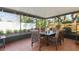 Screened-in lanai features tile flooring, outdoor seating, and a peaceful view of the backyard at 11125 117Th St, Seminole, FL 33778