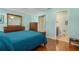 Spacious main bedroom features hardwood floors, a dresser, and access to the bathroom at 11125 117Th St, Seminole, FL 33778