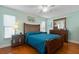 Comfortable main bedroom with hardwood floors, a ceiling fan, and wood furniture at 11125 117Th St, Seminole, FL 33778